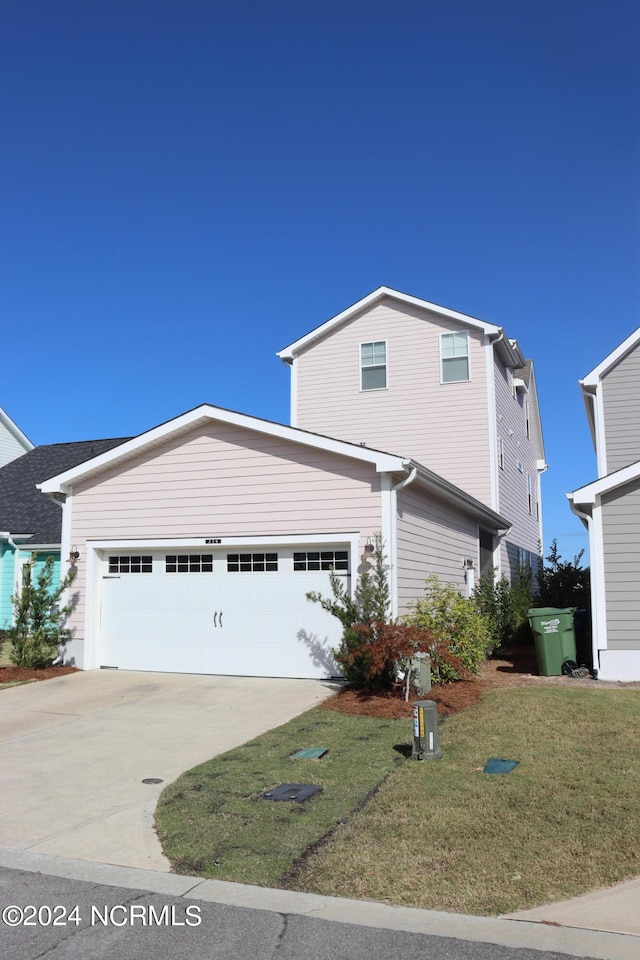 view of front facade with a front yard and a garage