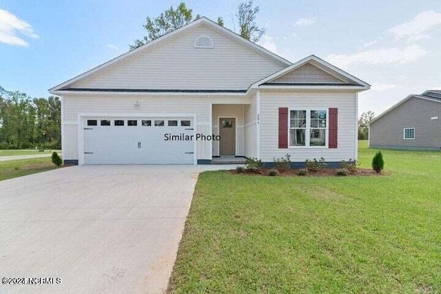 view of front of house with a front lawn and a garage