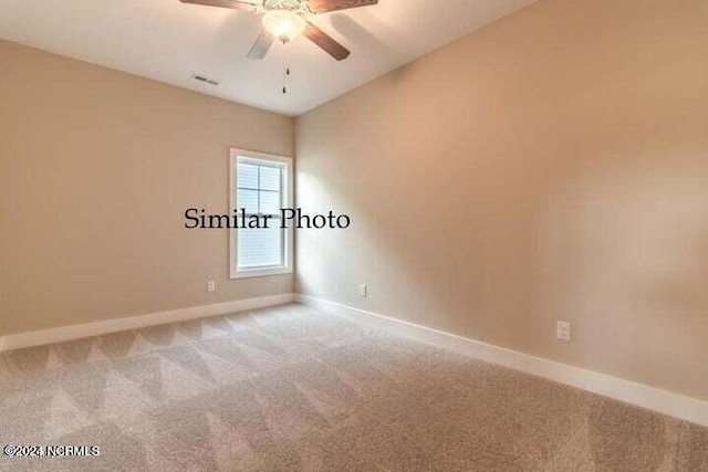 empty room featuring vaulted ceiling, ceiling fan, and carpet