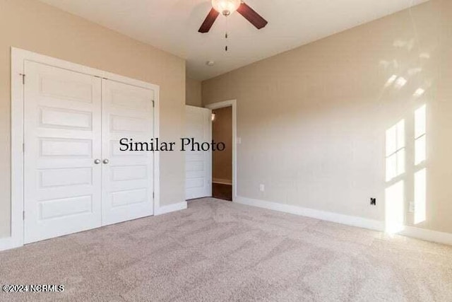 unfurnished bedroom featuring light colored carpet, ceiling fan, and a closet