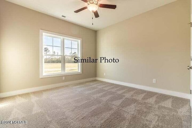 spare room featuring carpet flooring and ceiling fan