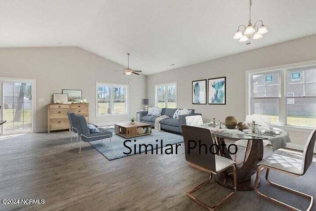 dining room featuring vaulted ceiling, ceiling fan with notable chandelier, and dark hardwood / wood-style flooring