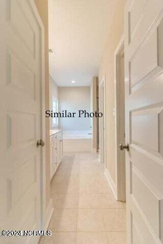 corridor featuring light tile patterned flooring