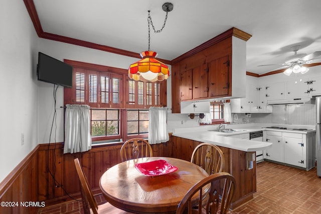 kitchen featuring pendant lighting, a wealth of natural light, kitchen peninsula, and white cabinets