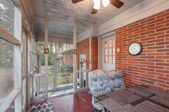 unfurnished sunroom featuring plenty of natural light and ceiling fan