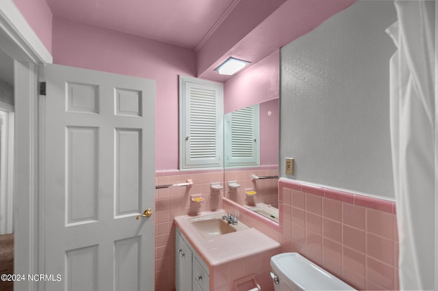 1008 S Howard Cir, Tarboro, NC 27886 - bathroom with vanity, toilet, tile walls, and a wainscoted wall