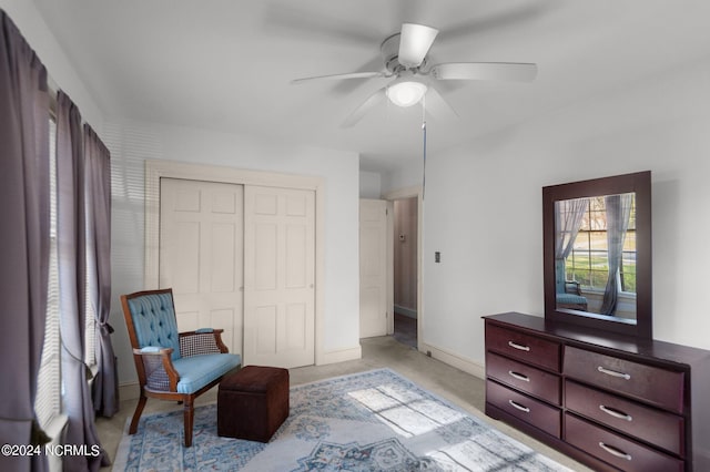 living area with ceiling fan and light colored carpet