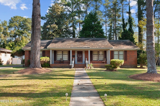 ranch-style home with a front yard and a porch