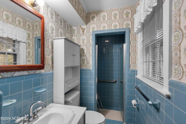 bathroom featuring vanity, tile walls, toilet, and an enclosed shower