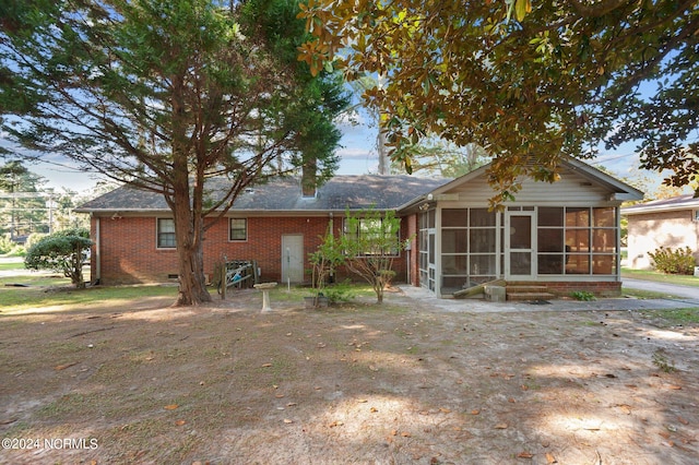 view of front of house with a sunroom