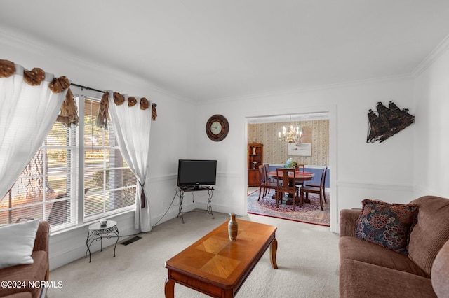 living room with crown molding, a notable chandelier, and carpet floors