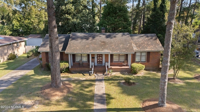 single story home featuring a front yard and a porch