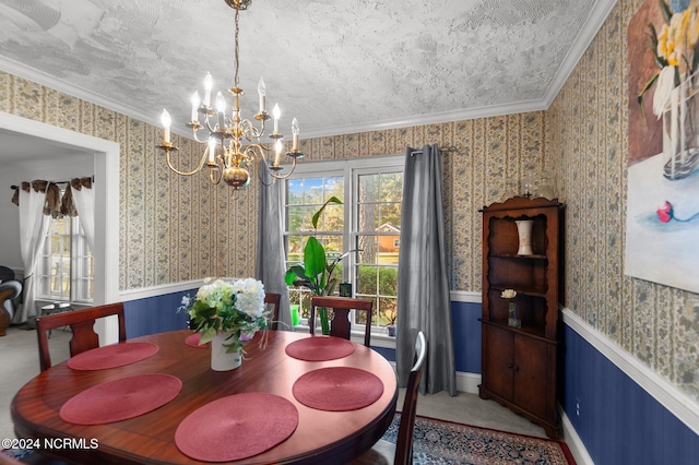 dining space featuring crown molding, a notable chandelier, a textured ceiling, and carpet floors