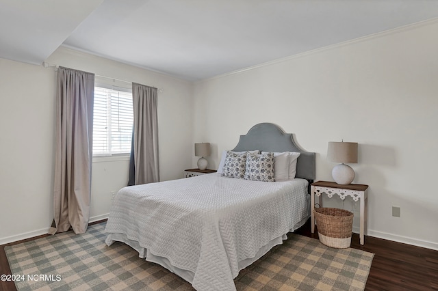 bedroom with crown molding and dark wood-type flooring