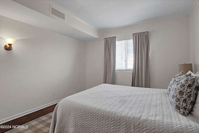 bedroom with wood-type flooring