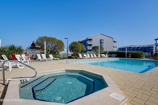 view of pool with a community hot tub and a patio area