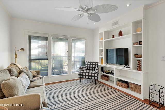 living room with ceiling fan, hardwood / wood-style flooring, and crown molding