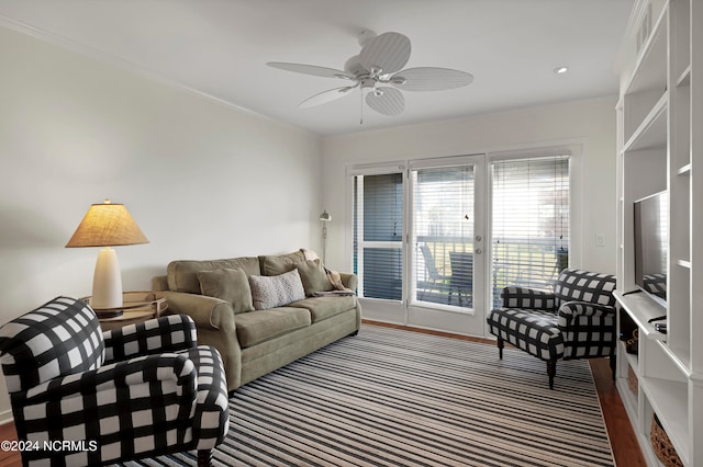 living room featuring ornamental molding, hardwood / wood-style flooring, and ceiling fan