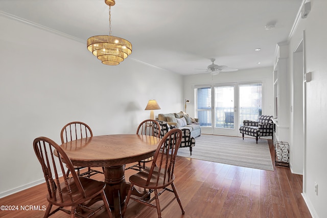 dining space featuring crown molding, ceiling fan, and dark hardwood / wood-style flooring