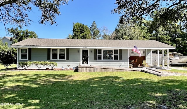 single story home featuring a front yard and a carport