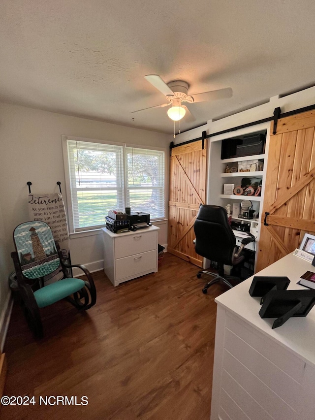 home office featuring ceiling fan, dark wood-type flooring, and a textured ceiling