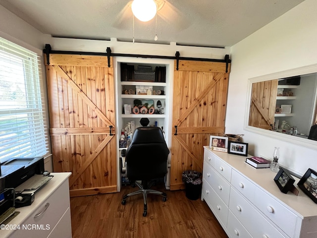 office featuring ceiling fan, a textured ceiling, plenty of natural light, and dark wood-type flooring