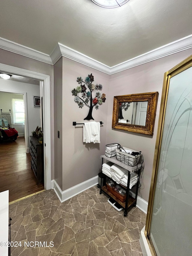 hall featuring dark hardwood / wood-style floors and crown molding