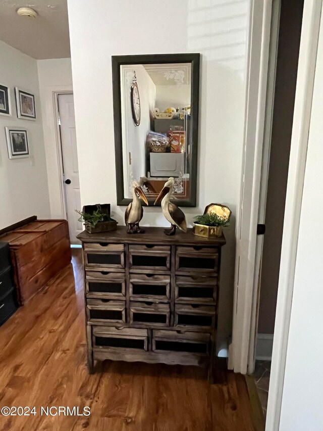 hallway with hardwood / wood-style flooring