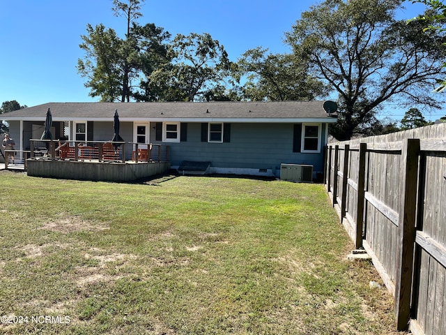 back of house featuring a yard and a deck