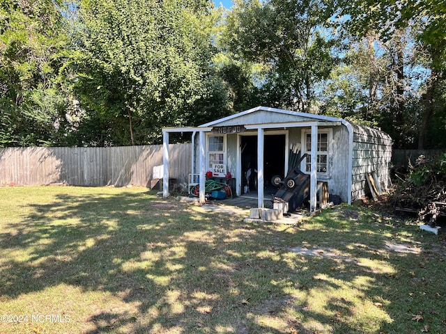 view of outbuilding with a lawn