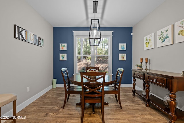 dining area featuring a notable chandelier and hardwood / wood-style flooring