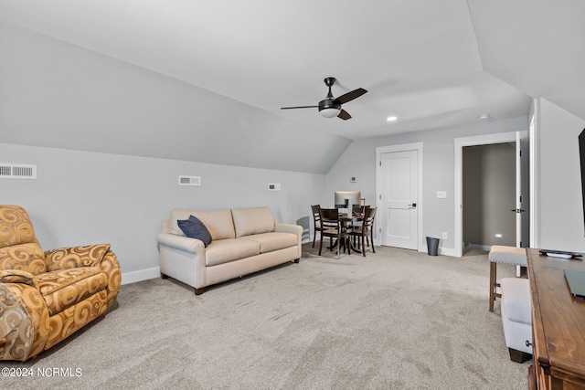 living room with ceiling fan, lofted ceiling, and light colored carpet