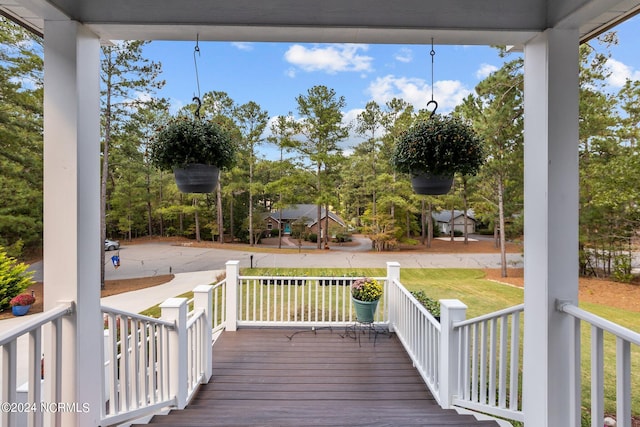 deck featuring a playground and a yard