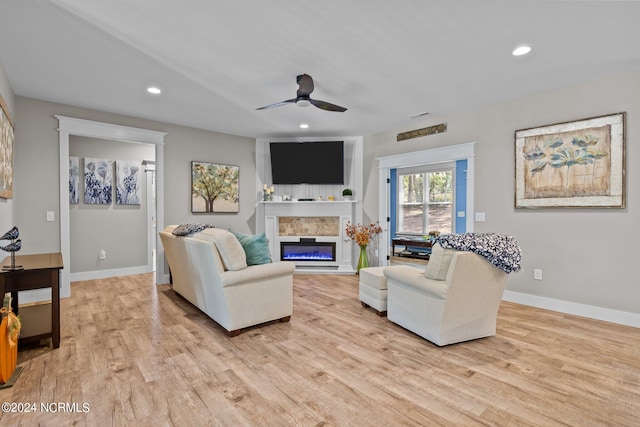 living room featuring ceiling fan and light wood-type flooring