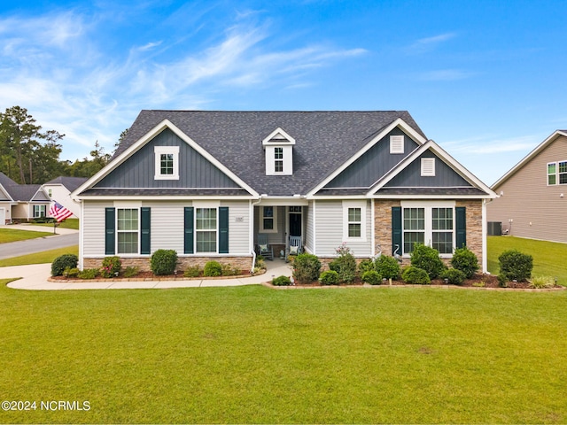 craftsman house with central AC unit and a front lawn