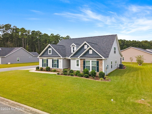 view of front of house with central AC unit and a front lawn