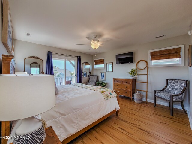 bedroom featuring access to outside, light wood-type flooring, and ceiling fan