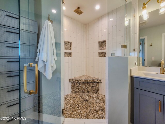 bathroom featuring vanity and tiled shower