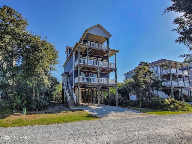 view of front of house featuring a carport and a balcony