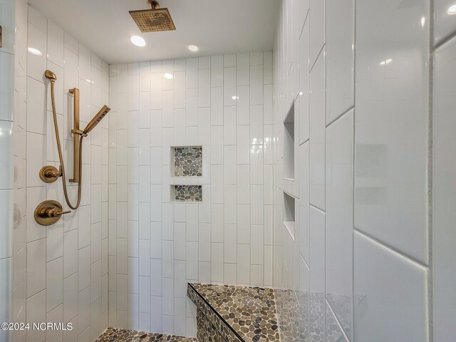 bathroom with a tile shower