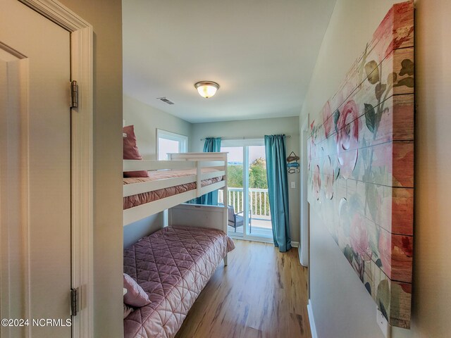 bedroom featuring access to exterior and light hardwood / wood-style flooring