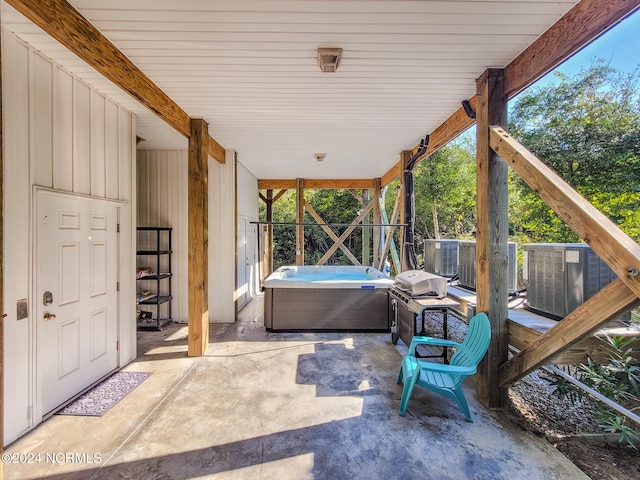 view of patio / terrace with central AC, a hot tub, and a grill