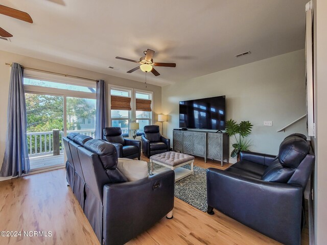 living room with ceiling fan and light hardwood / wood-style floors