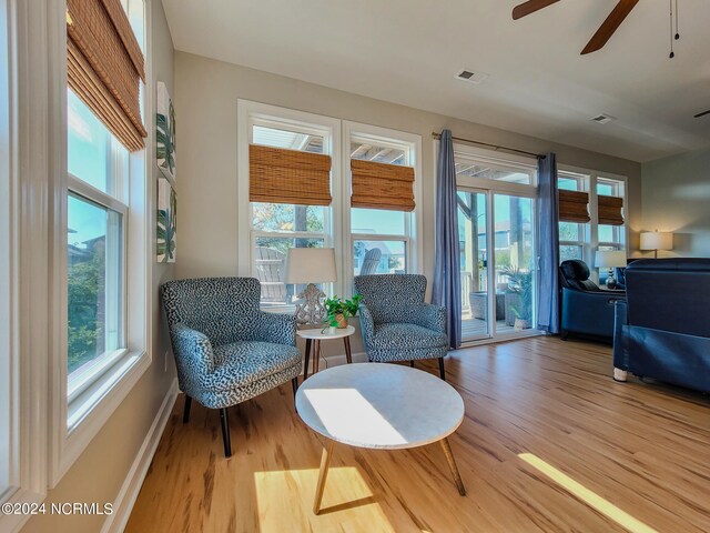 sitting room featuring wood-type flooring and ceiling fan