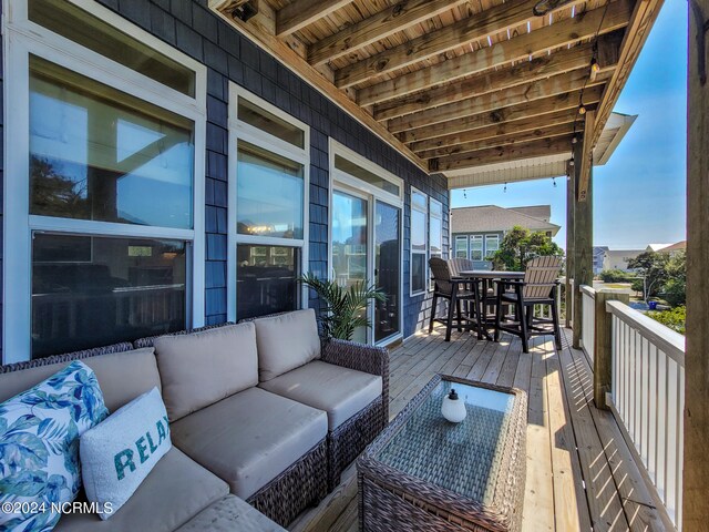 wooden terrace with an outdoor living space