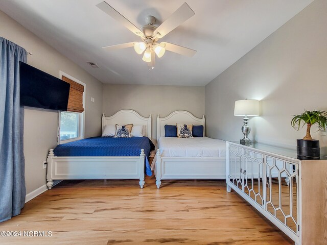 bedroom with ceiling fan and wood-type flooring