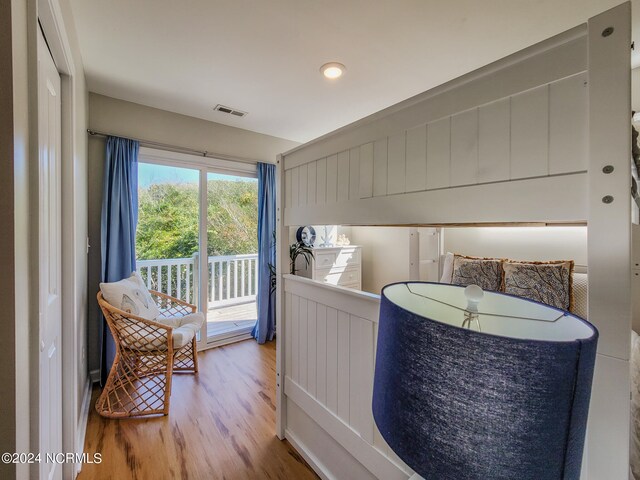 bedroom featuring access to exterior and hardwood / wood-style flooring