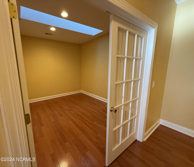 interior space featuring hardwood / wood-style flooring and a skylight