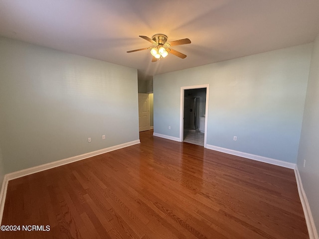 unfurnished room with dark hardwood / wood-style floors and ceiling fan