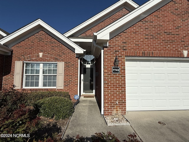 doorway to property featuring a garage